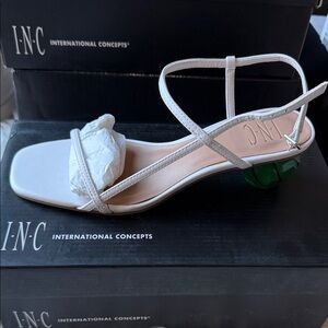 INC International Concepts white sandals with a green accent heel.